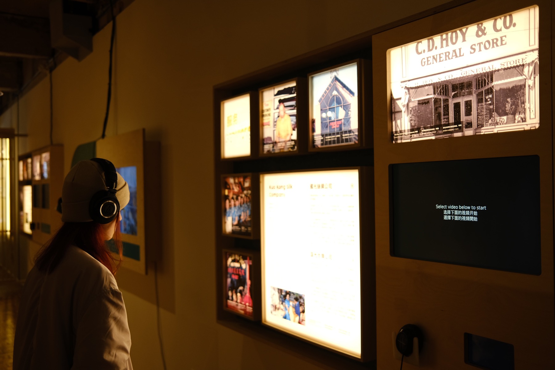 A still from the videopoem Contrasts: a dimly lit Vancouver Chinatown storefront at night.